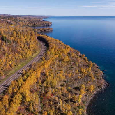 aerial view of highway winding along lake superior